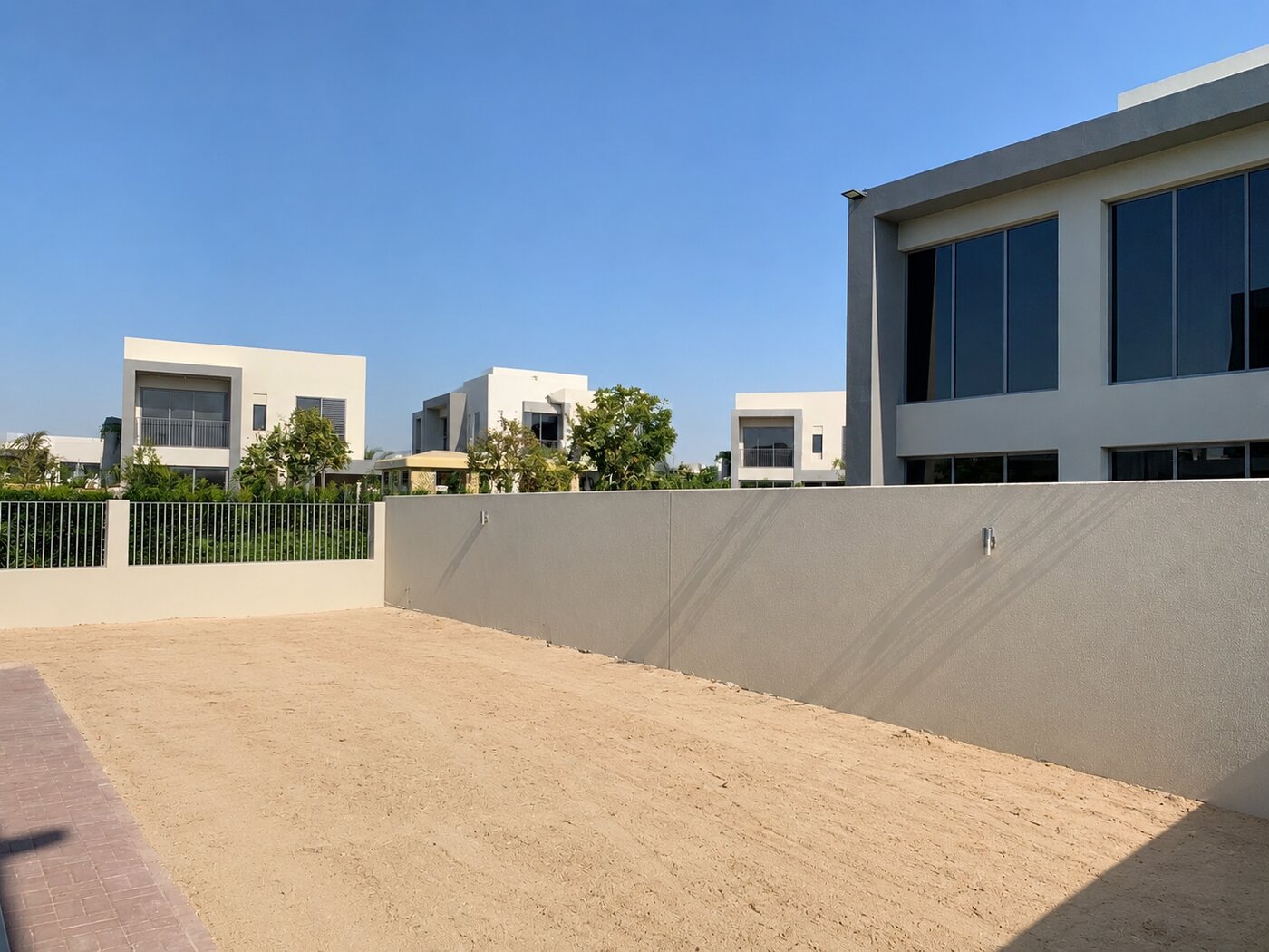 Dubai Hills Estate villa rear garden before landscaping — bare sand plot