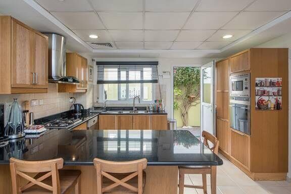 The Meadows villa kitchen before renovation — original dated cabinetry and layout