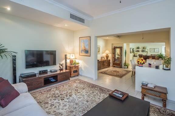 Dated original-condition living room with worn furnishings and traditional finishes, The Meadows villa before renovation