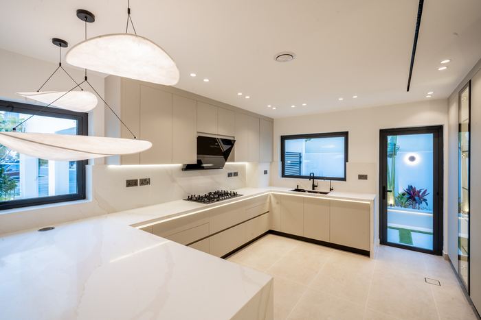 Kitchen with Waterfall Island &mdash; completed Crownstone villa renovation, Dubai