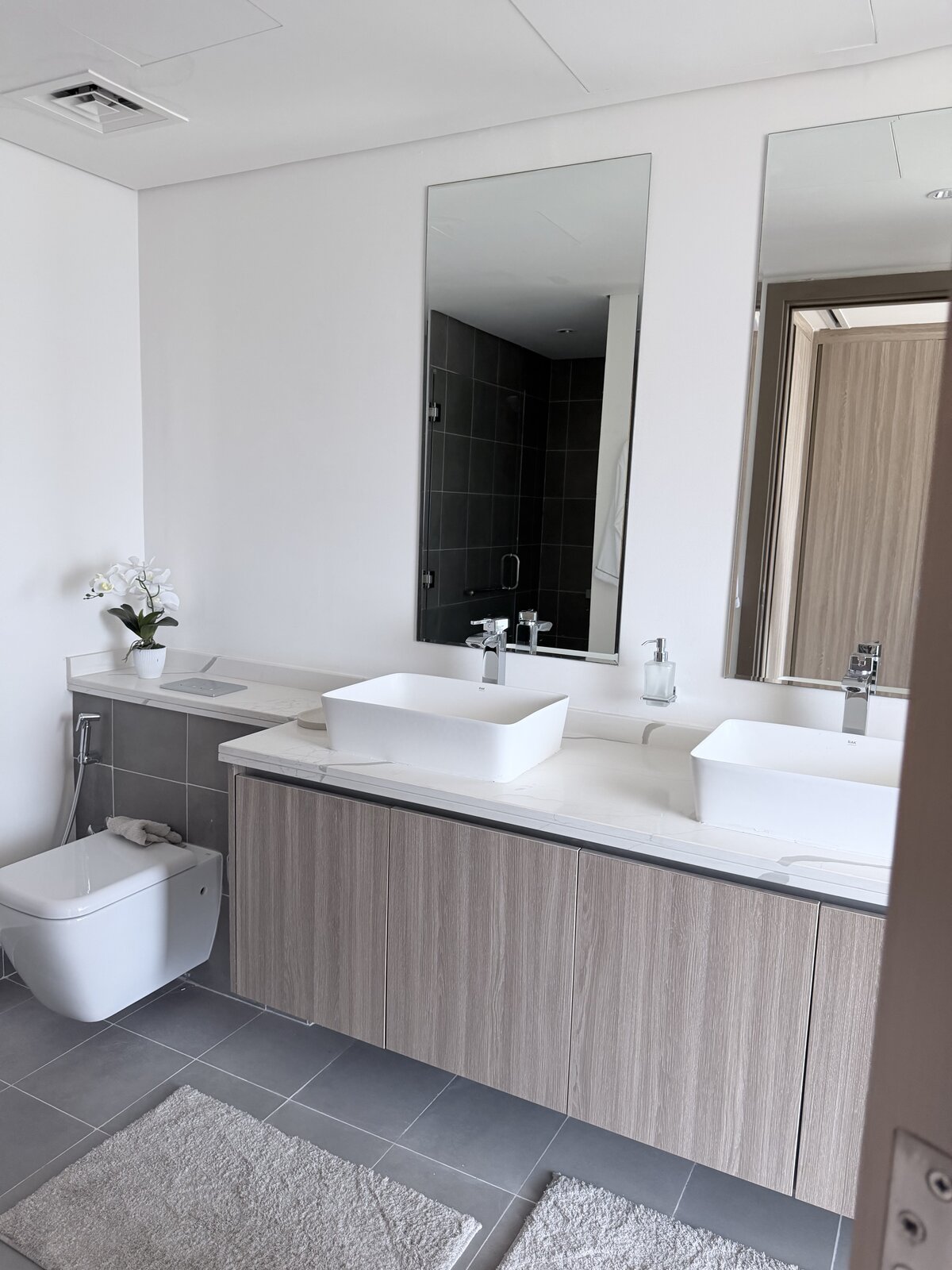 Palm Jumeirah townhouse bathroom after renovation, double vessel-sink vanity