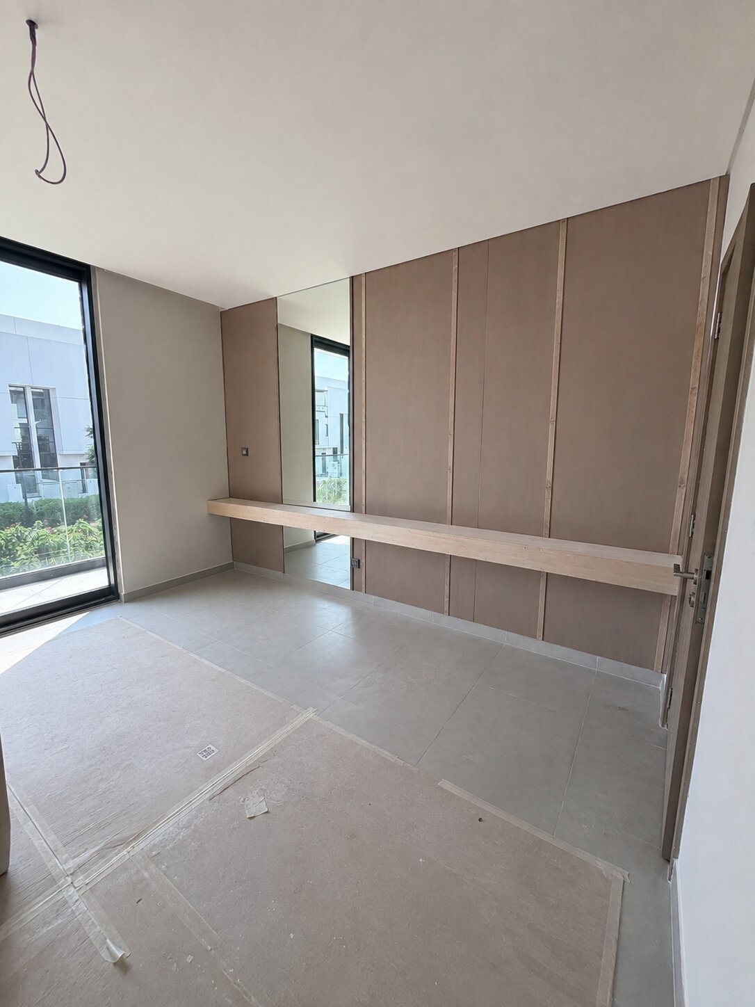 Palm Jumeirah townhouse dressing area before renovation — bare panelling, floor protection still down