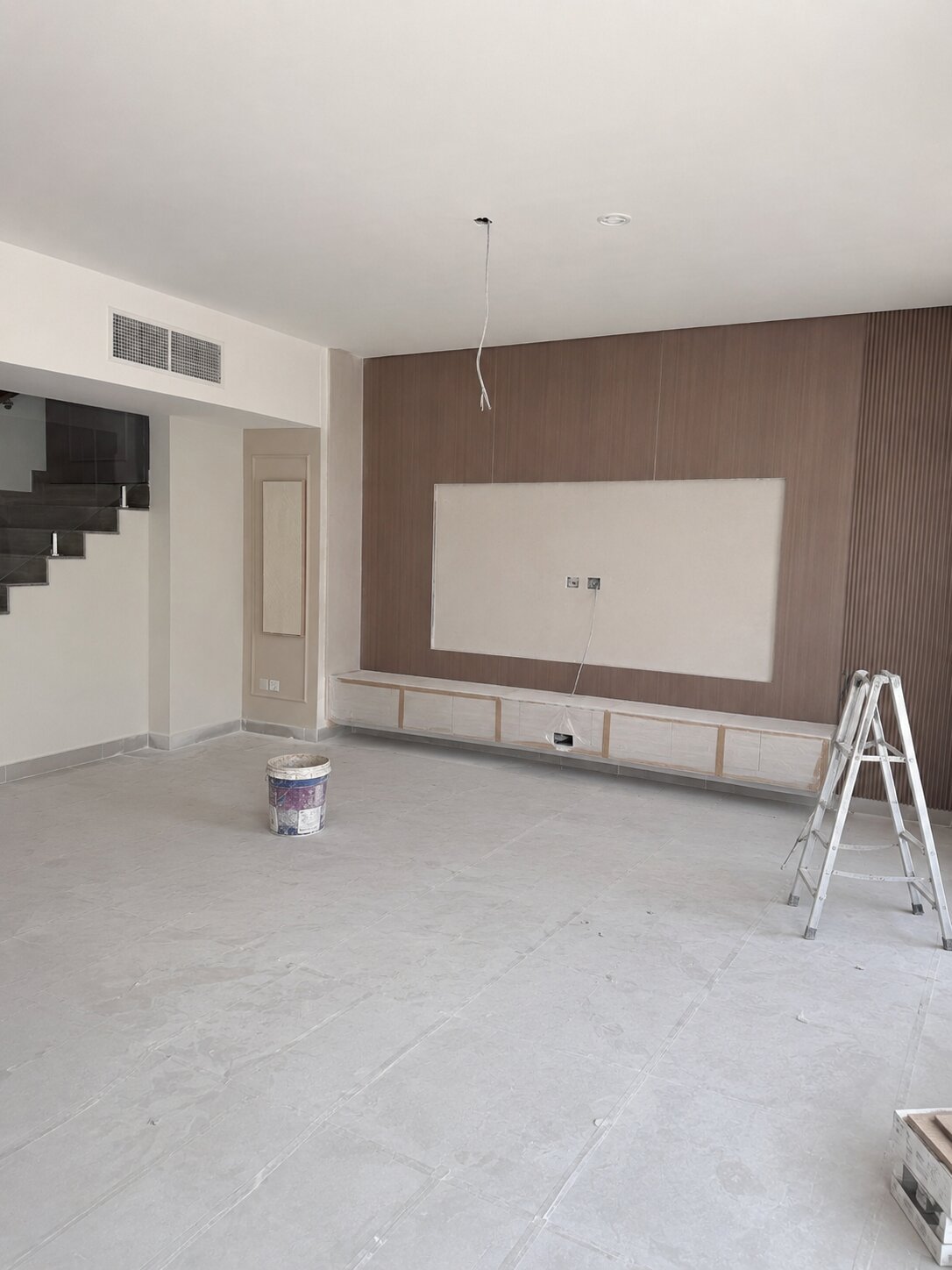 Palm Jumeirah townhouse living room before renovation — bare wall under construction, no furnishing
