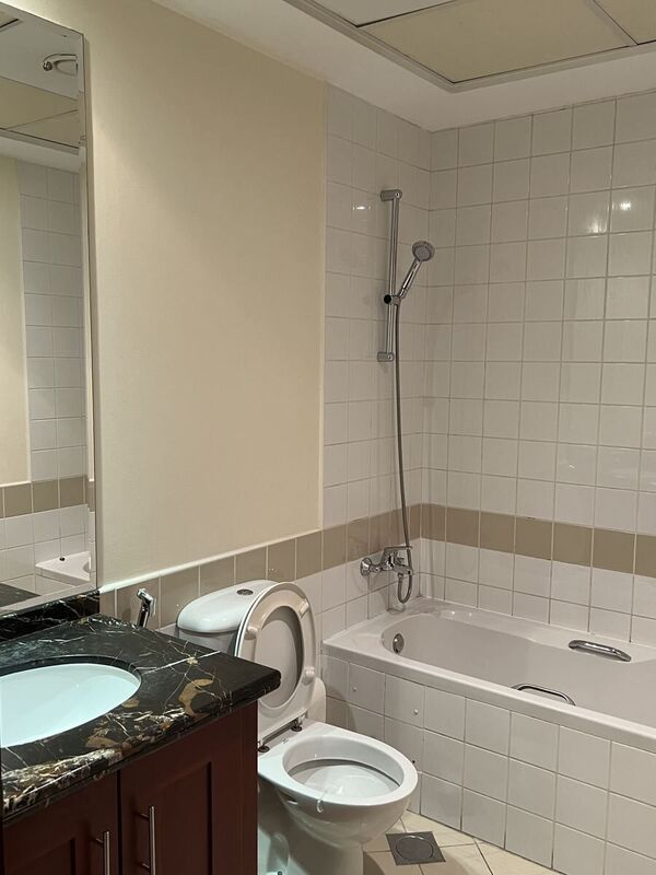 Arabian Ranches villa ensuite before renovation — original vanity, toilet and built-in tub