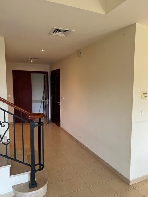 Palmera 4 villa hallway before renovation — original dark corridor
