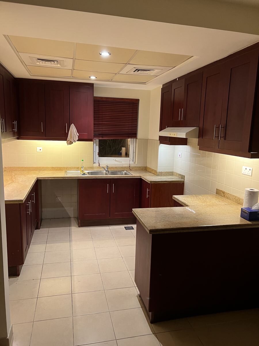 Arabian Ranches villa kitchen before renovation — original closed-off layout and dated cabinetry