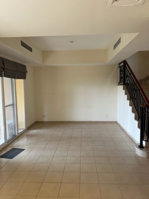 Arabian Ranches villa living room before renovation — original dated finishes